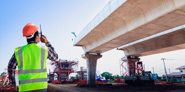 construction worker using a walkie talkie